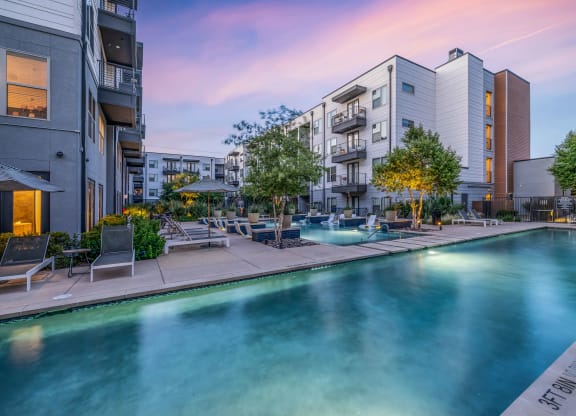 a swimming pool with apartments in the background
