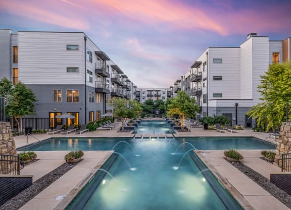 an apartment building with a swimming pool and buildings