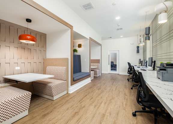 A modern office space with a wooden floor and a white table.