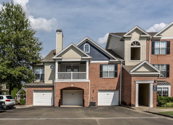 a house with two garages and a parking lot