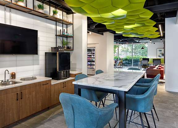 A modern kitchen with a dining table and chairs.