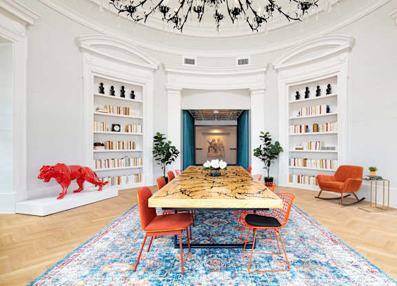 a dining room with a table and chairs and bookshelves