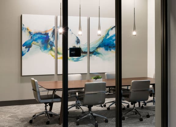 a conference room with a wooden table and chairs
