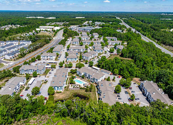 A bird's eye view of a residential area with houses and roads.