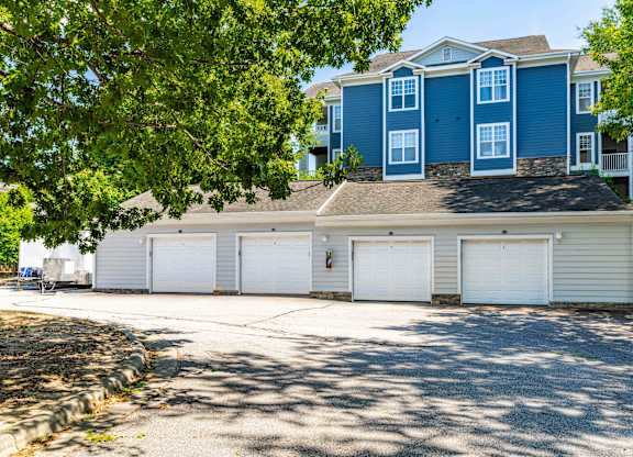 A blue house with white garage doors.