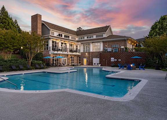 A large house with a pool in front.