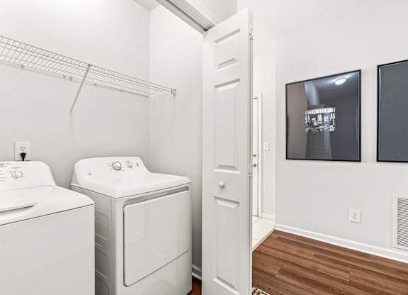 A white washer and dryer in a laundry room.