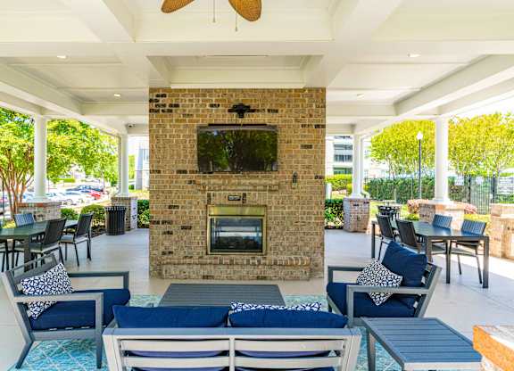 A patio with a fireplace and seating area.
