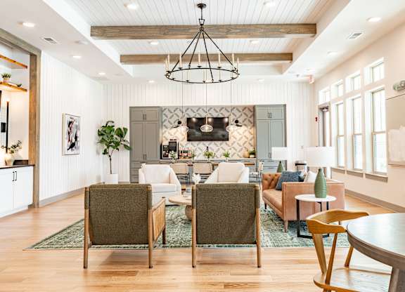 a living room filled with furniture and a large chandelier