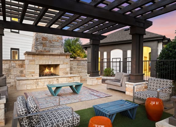 Twilight fireside lounge with stone fireplace and comfy seating