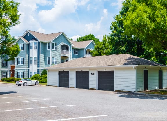 a garage with a car parked in front of an apartment building