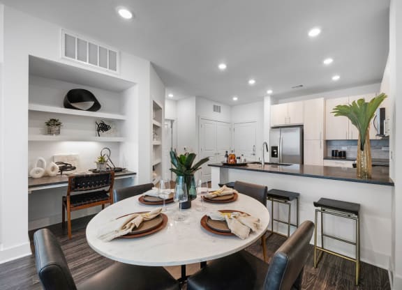 an open kitchen and dining area with a table and chairs
