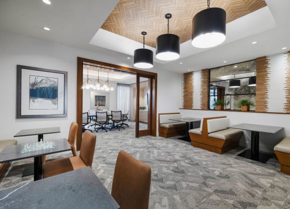 a dining room with tables and chairs and a geometric design on the wall