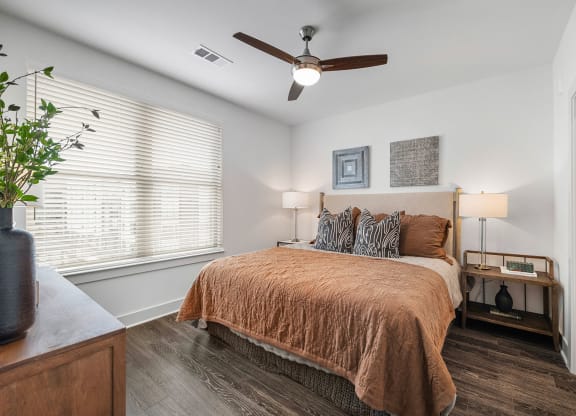 a bedroom with a bed and a ceiling fan