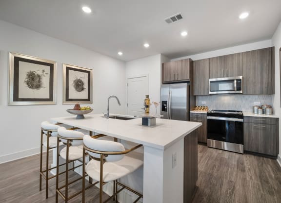 the residence on lamar apartment kitchen with island and stools
