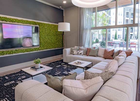 a living room filled with furniture and a large window