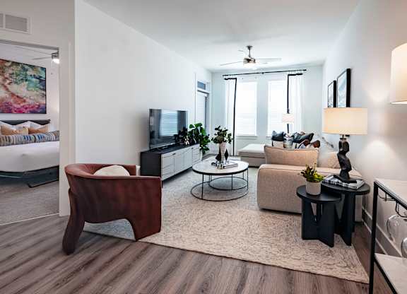 a living room with a couch and chair and a tv on a stand