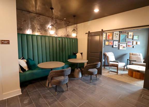 a dining room with a green booth and tables and chairs