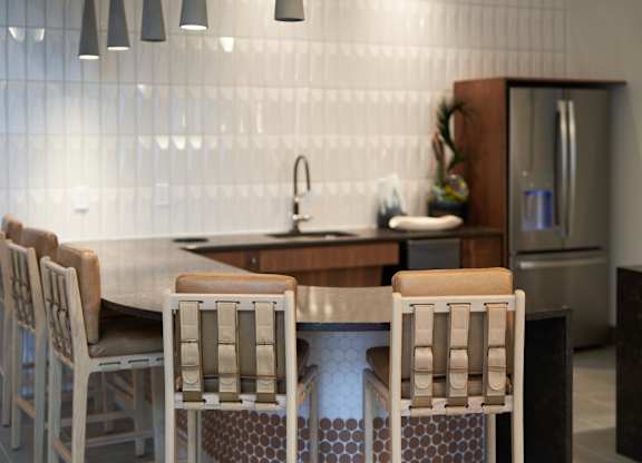 A kitchen with a table and chairs.