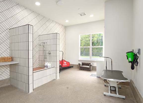 A room with a tiled wall and a table.