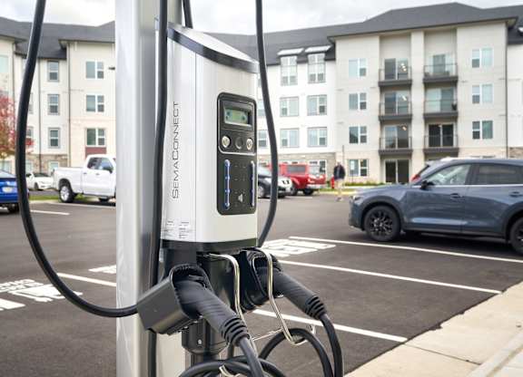 A charging station for electric vehicles is plugged in and ready to charge.