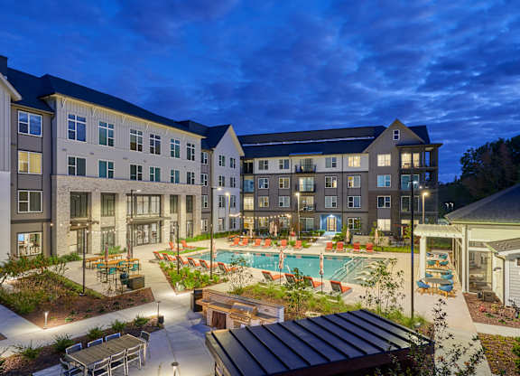 A large building with a pool in the courtyard.
