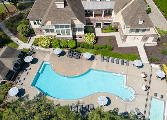 An aerial view of a house with a swimming pool.