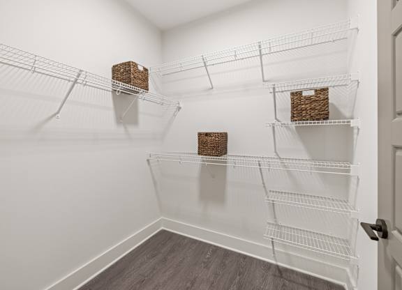 A white pantry with shelves and baskets.