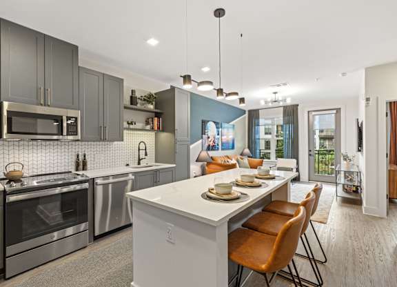 A modern kitchen with a dining table and chairs.