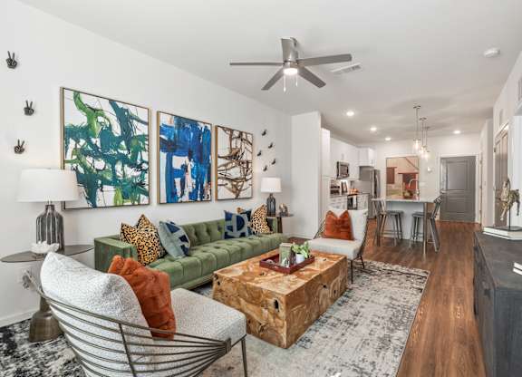A living room with a green couch and a wooden coffee table.