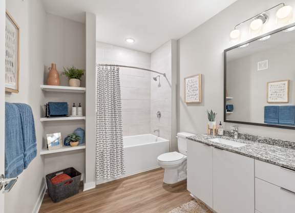 A bathroom with a white toilet, a white sink, and a white bathtub.