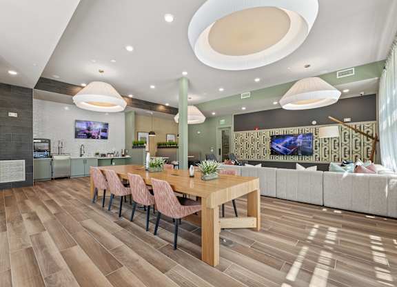 A modern dining room with a wooden table and chairs.