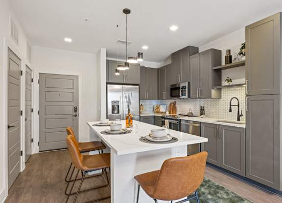 A modern kitchen with a dining table and chairs.