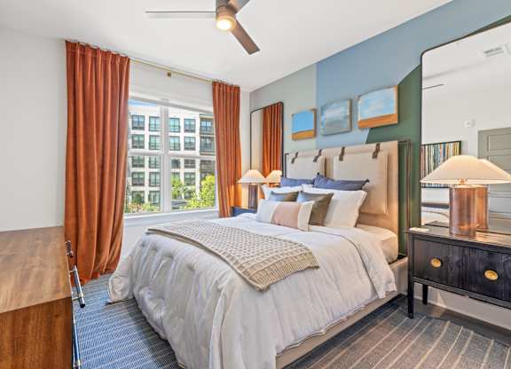 A bedroom with a large bed and a wooden headboard.