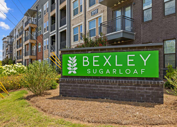 A sign for Bexley Sugarloaf in front of a building.