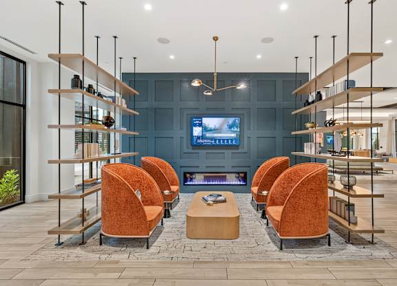 A modern living room with a fireplace and a television.