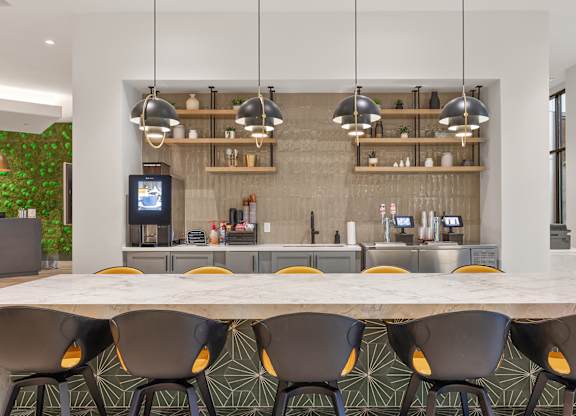A modern kitchen with a long table and chairs.