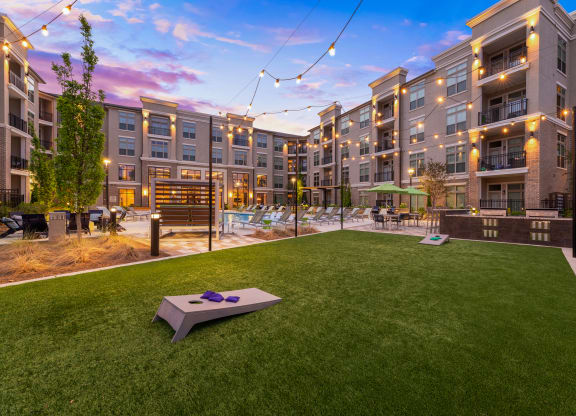 a backyard with a trampoline and a hot tub