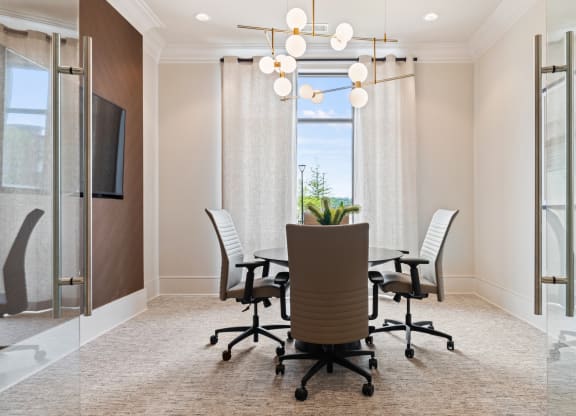 a conference room with a table and chairs