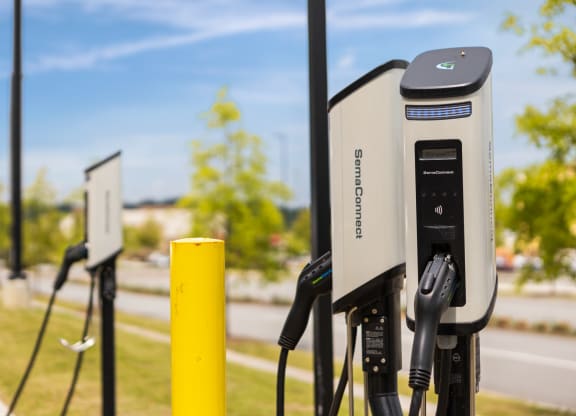 a row of electric car chargers in a park