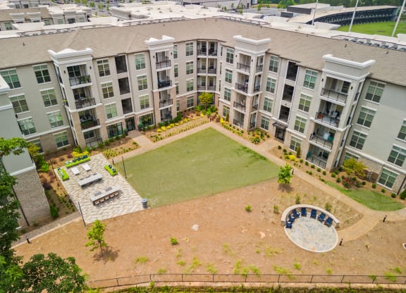 an aerial view of an apartment complex with a large lawn