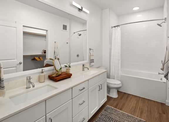 a bathroom with white cabinets and a shower and a toilet