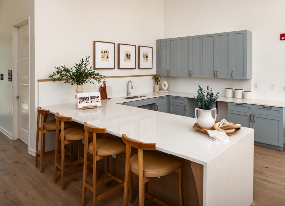 a kitchen with a white counter top and blue cabinets