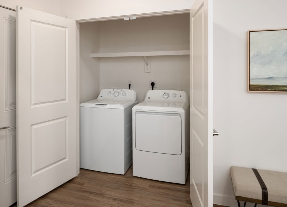 a laundry room with two washes and a dryer in it