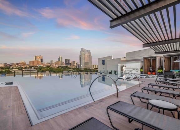a swimming pool with a city skyline in the background