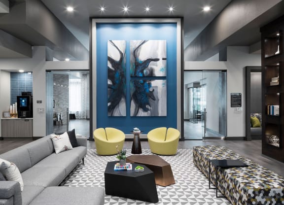 a living room with a blue wall and a couch and tables