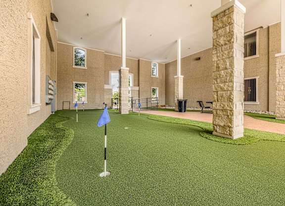 A miniature golf course is set up inside a building.