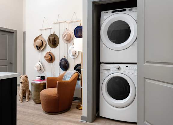 A white washing machine is in a doorway.