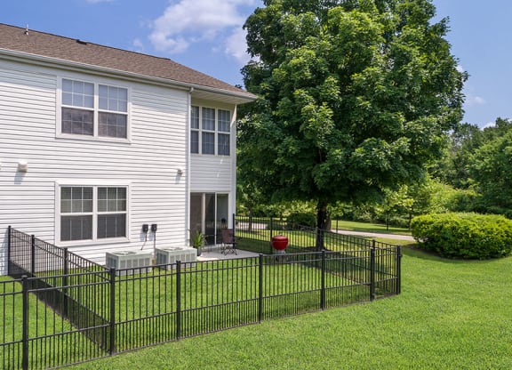 a large white house with a black fence in front of it