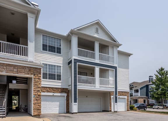 a house with two garages and two cars in front of it